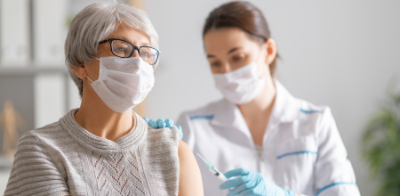 A healthcare professional administers a vaccine to a patient.